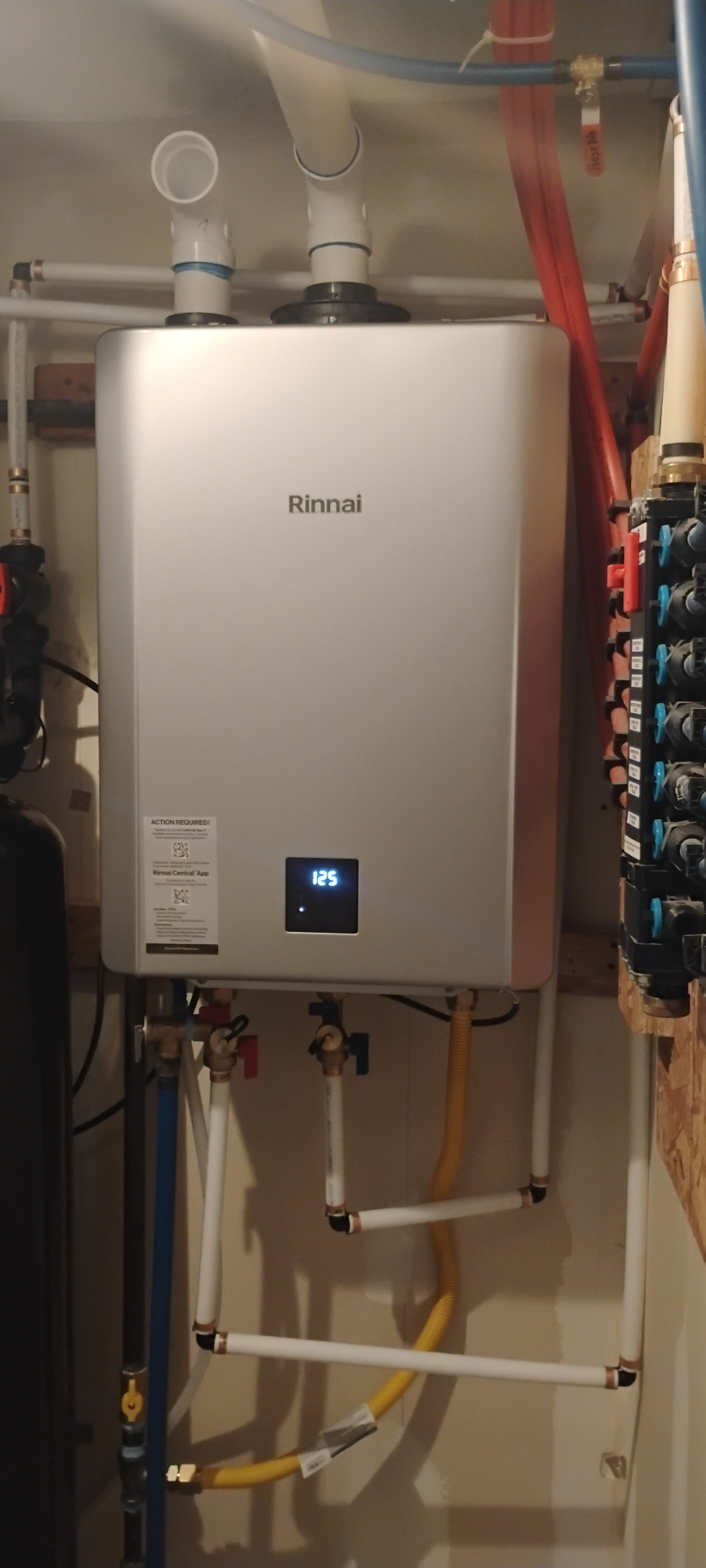 Wall-mounted Rinnai tankless water heater with new gas and water lines